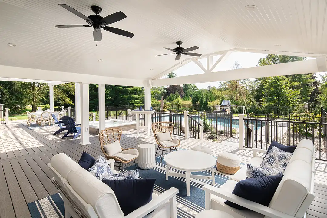 Photo of a large, extensive custom covered deck with several distinct areas, including a relaxation area and an outdoor living room.