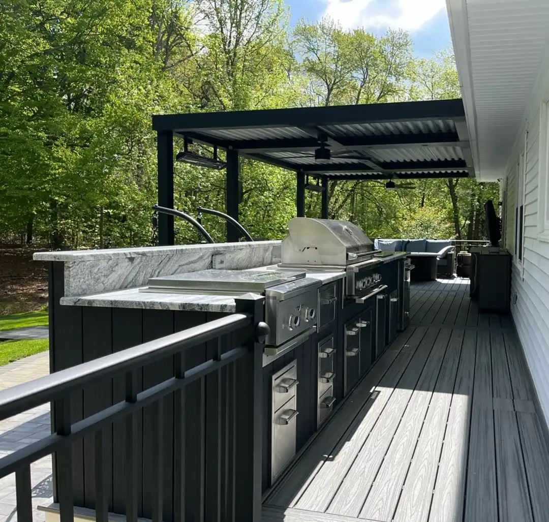 Photo of a custom deck with outdoor kitchen and pergola.