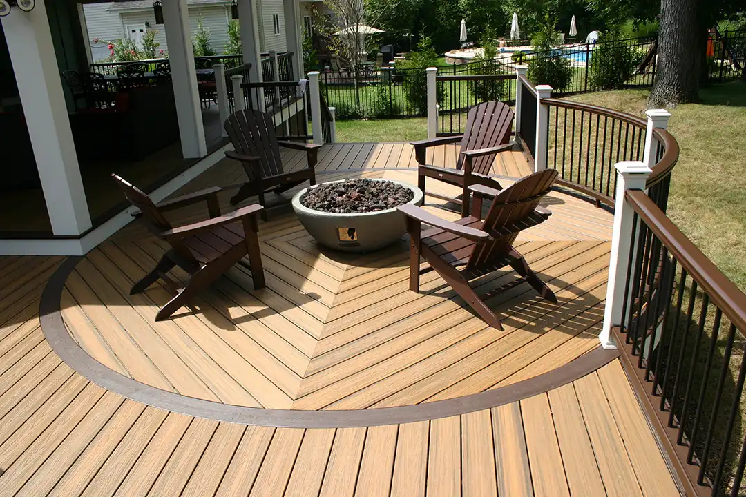 Photo of a custom composite deck with artistic circular deck area with deck boards angled in a pattern.