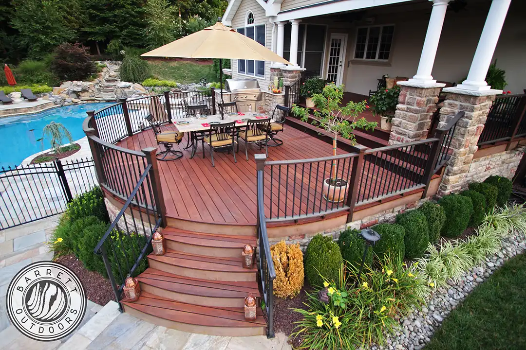 Photo of a mutli-level, curved deck with covered area and outdoor dining area.
