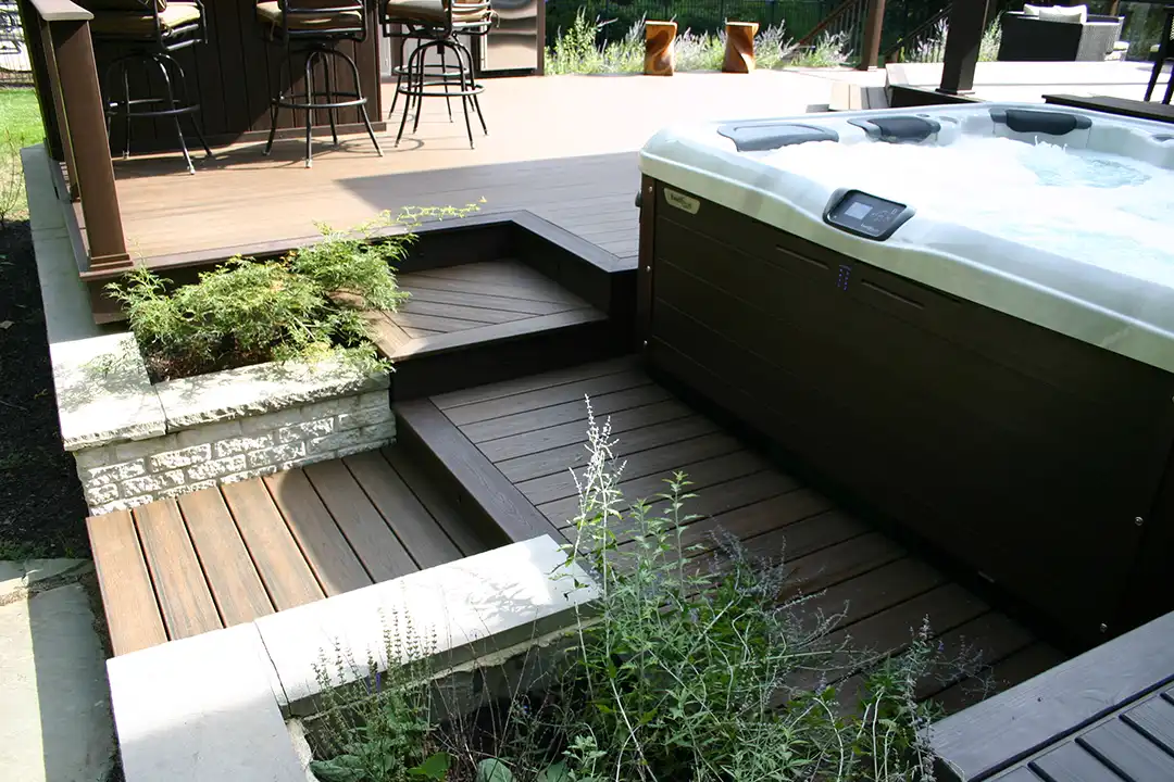 Photo of multi-level deck with an outdoor bar and hot tub.