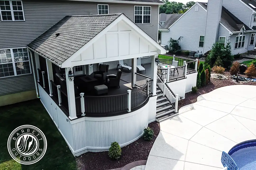 Photo of a covered curved deck with steps and deck railing