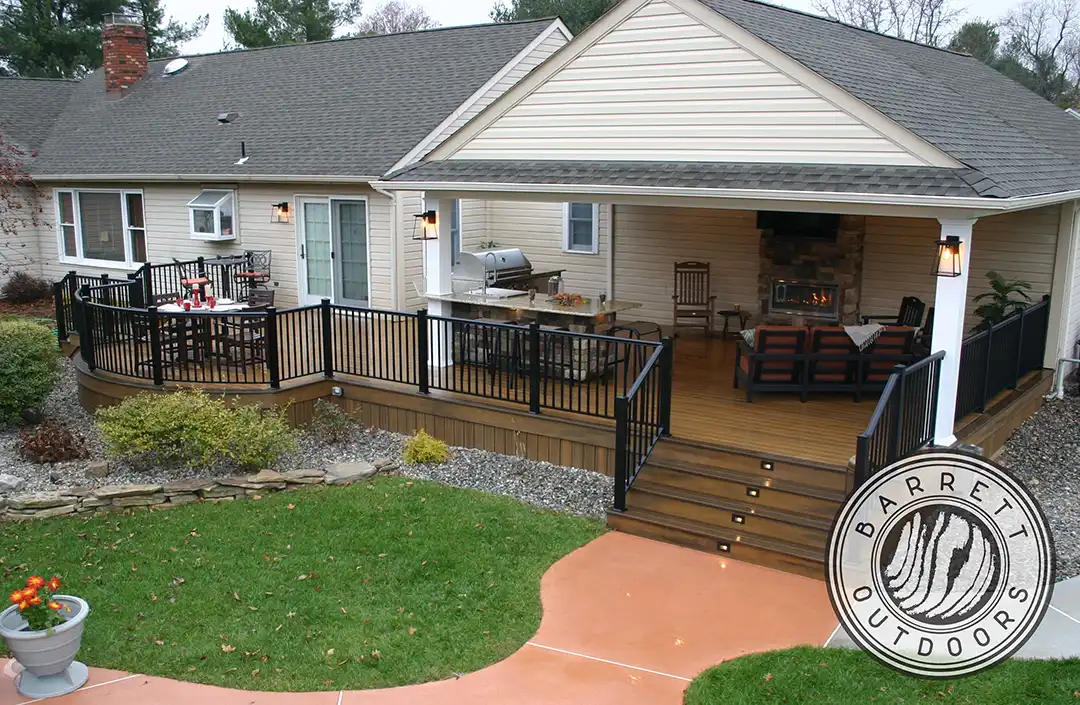 Photo of a custom deck featuring a covered deck area and a curved deck area with black railing and lights recessed into the steps in Upper Freehold