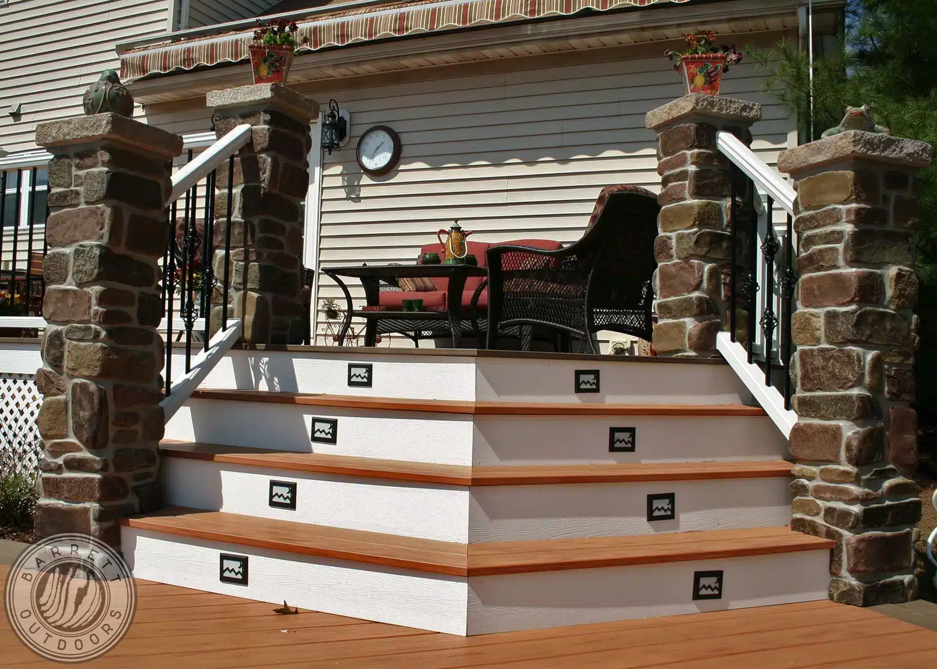 Photo of multi-level deck with stone posts, angled steps, and in-step lighting