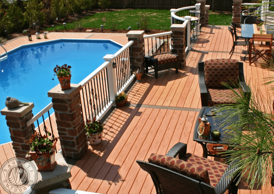 photo of elaborate pool deck with deck railing, columns, and outdoor furniture