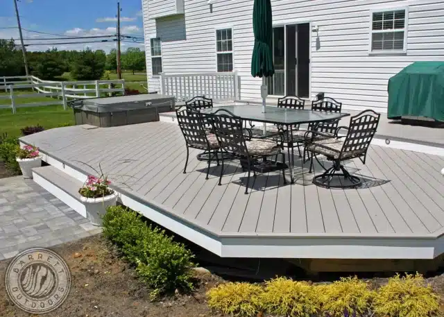 photo of a ground-level deck with outdoor furniture.